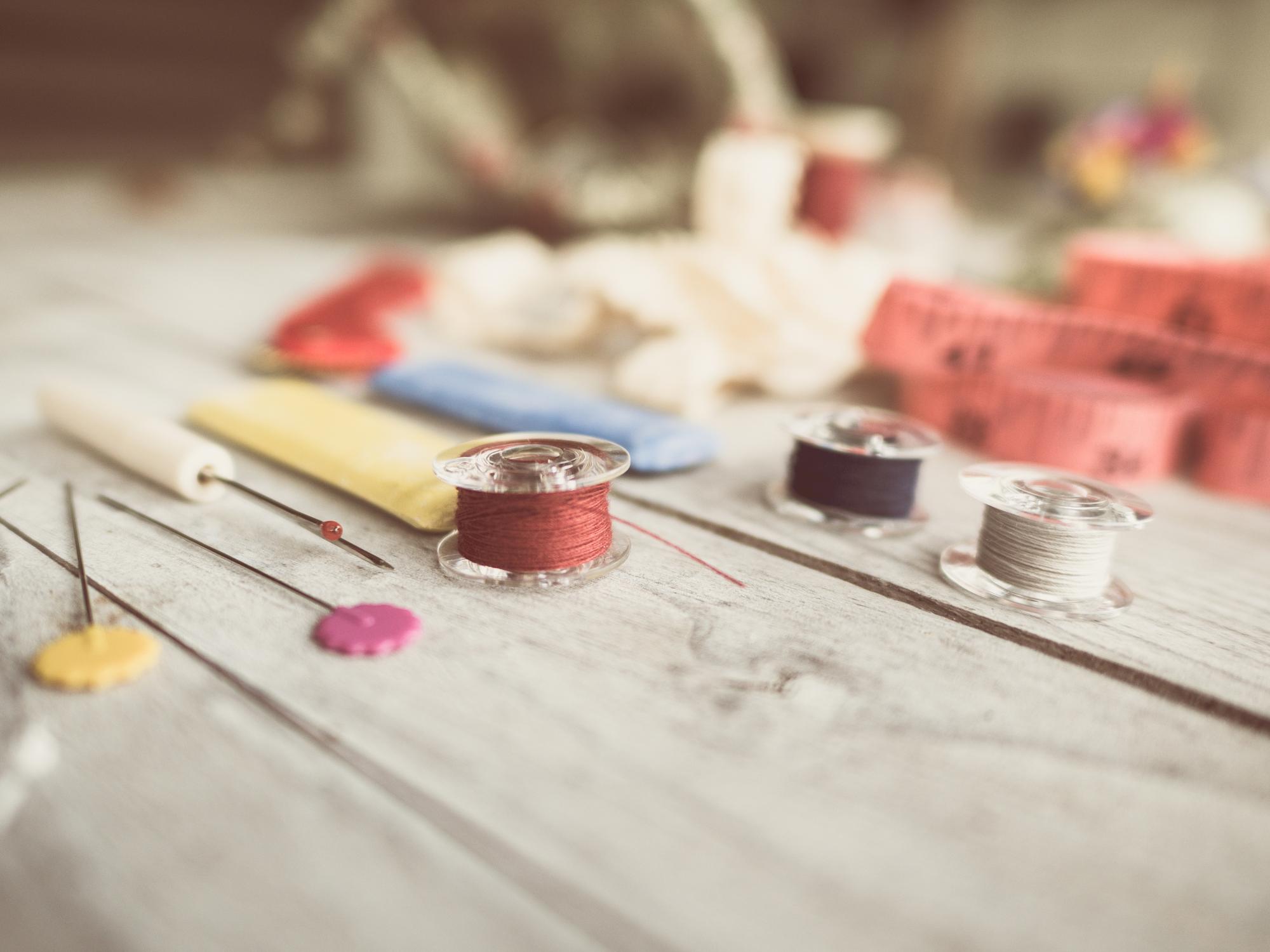 Workspace with threads, needles and sample swatches